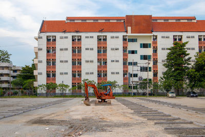 Exterior of building by street in city against sky