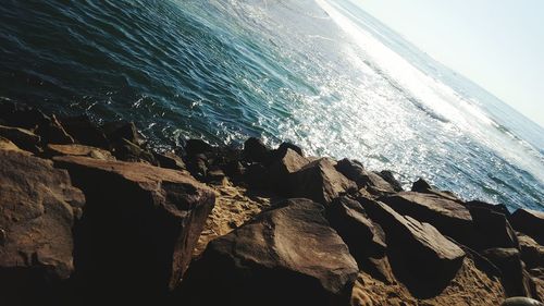 Scenic view of rocks in sea against sky