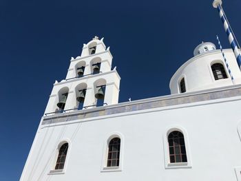 Low angle view of building against clear blue sky