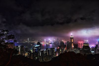 Cityscape against dramatic sky at night