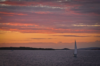 Scenic view of sea against orange sky