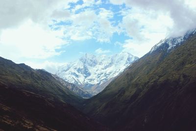 Scenic view of mountains against cloudy sky