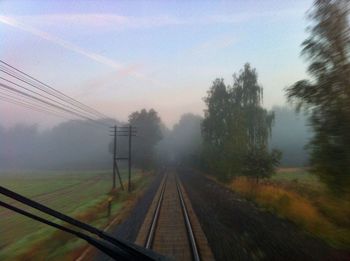 Railroad track passing through foggy weather
