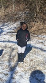 Portrait of young woman standing outdoors