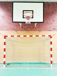 View of basketball hoop against brick wall