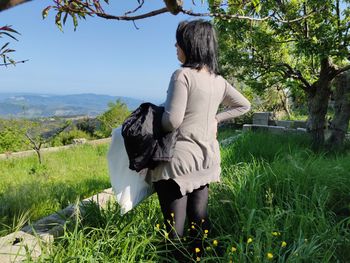 Rear view of woman on field