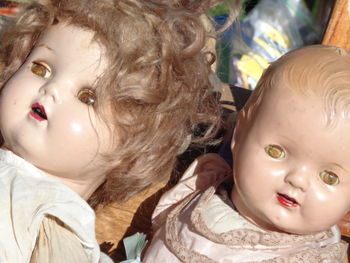 A pair of antique dolls showing their age and wear