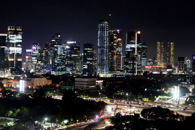 Illuminated cityscape against sky at night