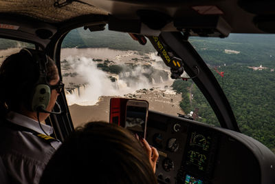 Rear view of man seen through airplane window