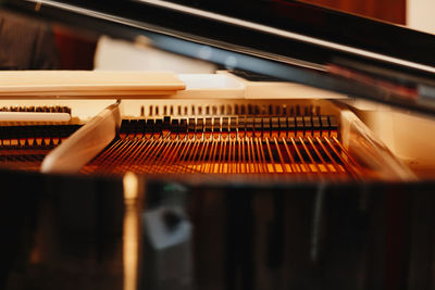 Close up of pattern of hammers and strings inside grand piano