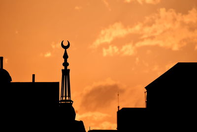 Low angle view of silhouette building against sky during sunset