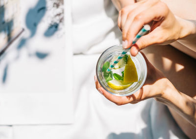 Midsection of woman holding drink