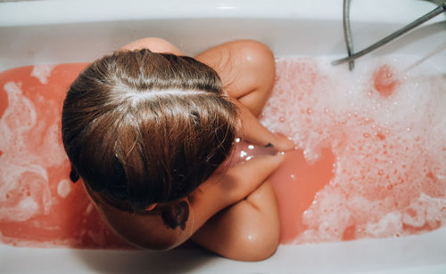 Directly above shot of woman relaxing in bathtub