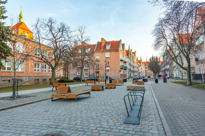 Rear view of woman sitting on bench in park