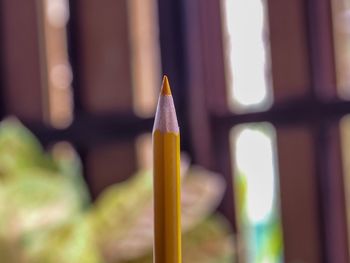 Close-up of yellow pencils on building