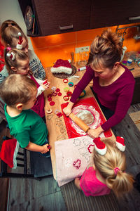 Woman preparing food with children at home