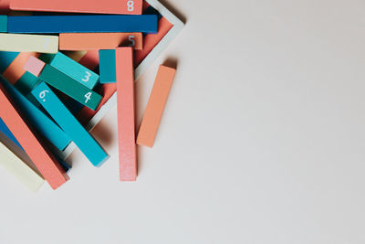 High angle view of multi colored toys on white table