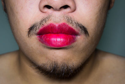 Close-up of man wearing lipstick
