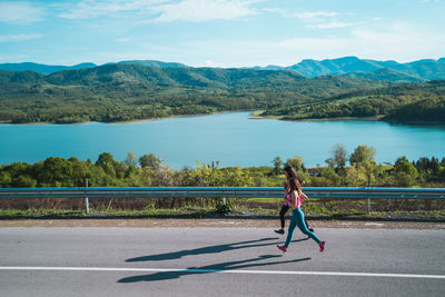 Full length of woman on road against sky