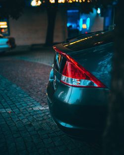 Close-up of illuminated car on street at night