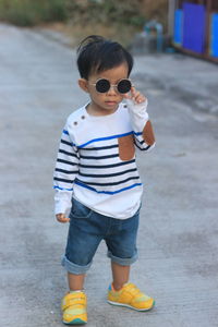 Asian boys wearing black fashion glasses and white striped shirts.