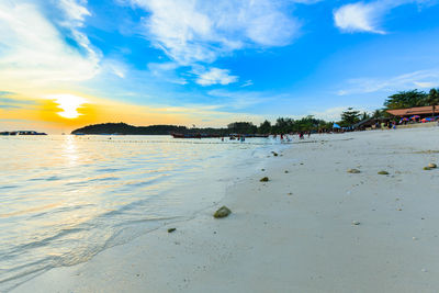 Scenic view of beach against sky during sunset