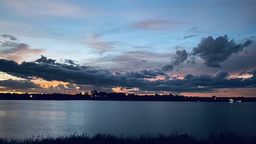 Scenic view of lake against sky at sunset