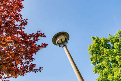 Low angle view of street light against clear blue sky