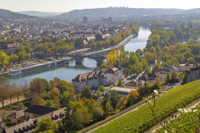 High angle view of bridge over river amidst buildings in city