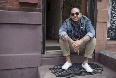 A young man on a doorstep.