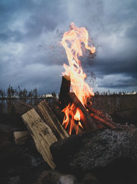 Bonfire by the sea against sky