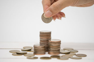 Close-up of hand holding coins