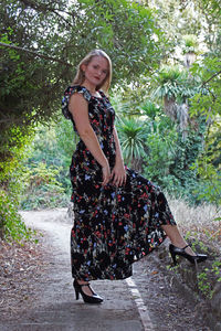 Portrait of young woman against plants