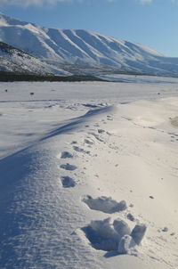 Scenic view of snow covered mountain against sky