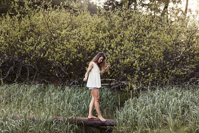 Natural beauty with tattoos in a meadow in ucluelet