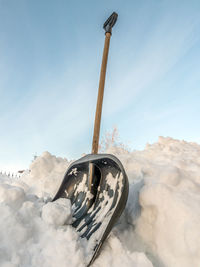 Shot of snow clearing shovel driven into thick snow cover