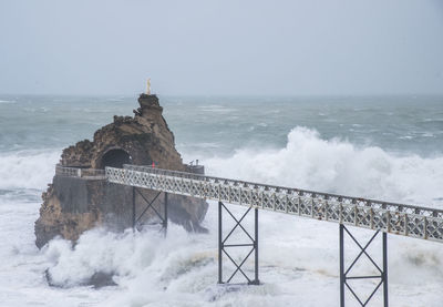 Scenic view of sea and lighthouse against sky