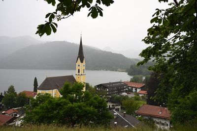St sixtus church by lake schliersee during foggy weather