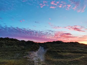 Scenic view of land against sky during sunset