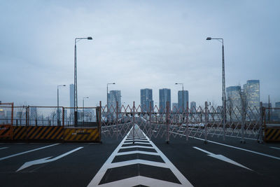 View of road and cityscape against sky