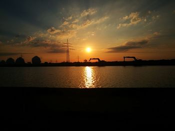 Scenic view of lake against sky during sunset