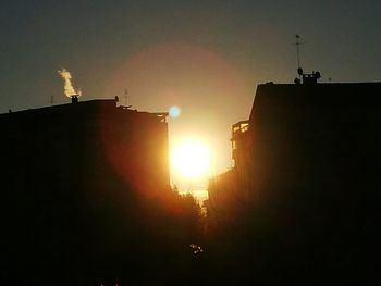 Low angle view of silhouette building against sky during sunset