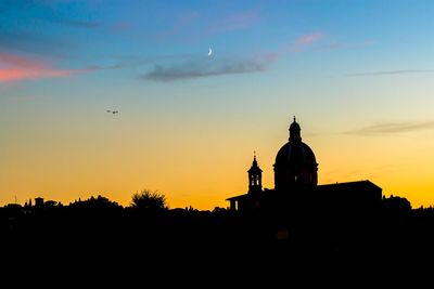 Silhouette temple against sky during sunset