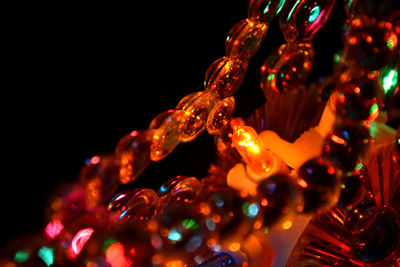Low angle view of illuminated lights against sky at night