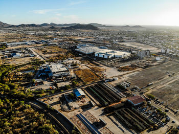 Aerial view of buildings in city against sky