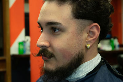 Close-up portrait of young man looking away
