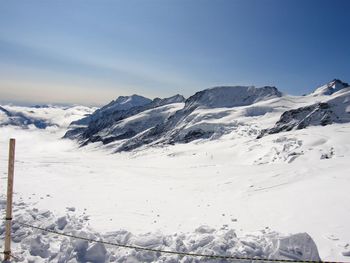 Scenic view of snowcapped mountains against clear sky