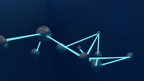 Close-up of machine part over black background