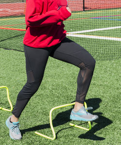Low section of person standing on soccer field