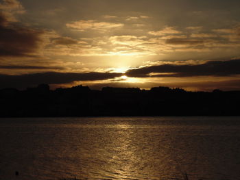 Scenic view of dramatic sky over silhouette landscape